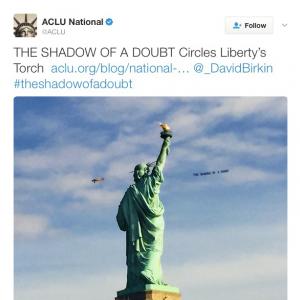 'The Shadow of a Doubt', ACLU tweet of airplane banner circling The Statue of Liberty; from the project 'Severe Clear', 2014