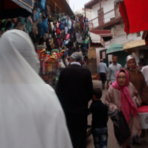 Asian woman with Islamic clothes walking in Sefrou, Morocco