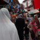 Asian woman with Islamic clothes walking in Sefrou, Morocco